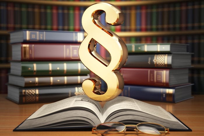 Paragraph sign on the vintage book in library. Law concept.